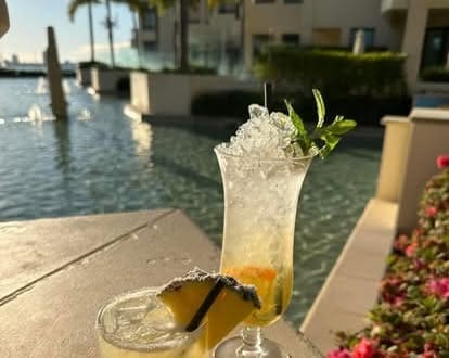 sort poolside with refreshing drinks and a stunning waterfront view in Gold Coast.